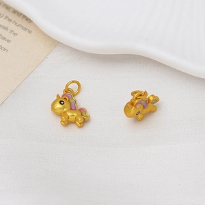 Detailed close-up of golden unicorn charms with colorful enamel finish for DIY jewelry