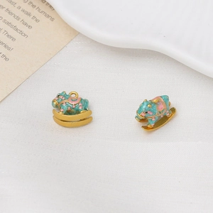 Detailed macro view of enamel rocking horse charms with blue finish and golden accents