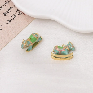 Detail view of light blue enamel rocking horse pendants with gold plating and zircon