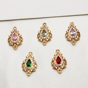Macro shot of colorful teardrop zircon charms in gold plating for jewelry making