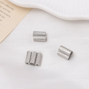 Macro shot of silver textured cylindrical magnetic clasps for multi-strand necklaces