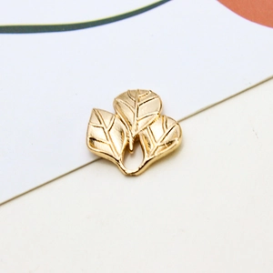 Detalle de colgantes de hoja de ginkgo dorada con vetas para creación de joyas artesanas