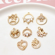 Macro shot of gold-plated pendant charms with zircon accents for DIY jewelry making