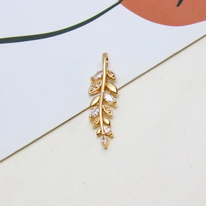 Detailed close-up of golden leaf pendant with marquise-cut cubic zirconia for DIY jewelry