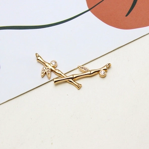 Close-up of golden bamboo shaped jewelry pendant with micro-pave cubic zirconia stones