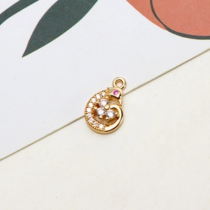 Detailed close-up of a bird pendant with micro-set zircons and pink gemstone eye