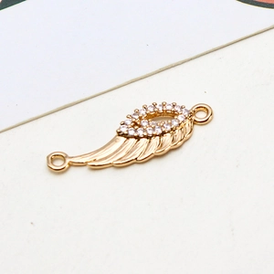Macro shot of gold-plated wing pendant connector with pavé zircon stones for DIY jewelry