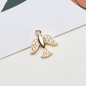 Detailed macro view of gold bird pendant with white cubic zirconia for DIY jewelry