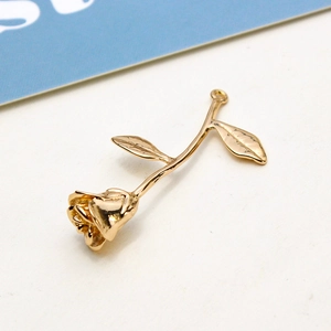 Detailed macro view of a 3D golden rose pendant for DIY jewelry and hair accessories
