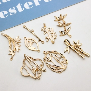 Golden bamboo-shaped pendants for DIY jewelry making including stems and leaf charms