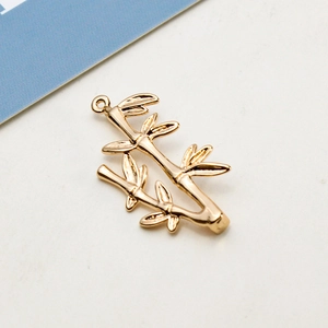Macro shot of gold-plated bamboo branch pendant with detailed textures for DIY jewelry