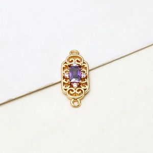 Detail of gold-plated rectangular pendant with purple zircon and symmetrical small white stones
