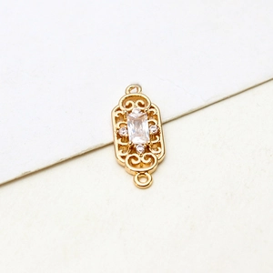Macro view of gold-plated rectangular pendant with zircon inlay and hollow details