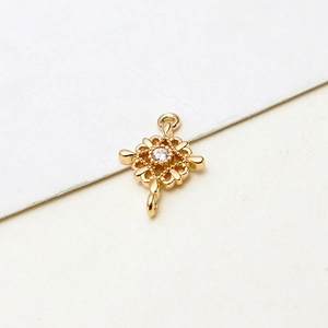 Macro shot of gold-plated rectangular filigree pendant with centered zircon for jewelry DIY