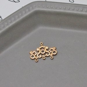 Macro shot of gold vintage filigree pendant with multi-hole design for DIY jewelry