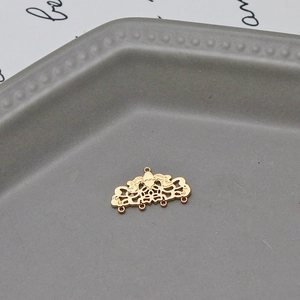 Detailed close-up of a gold filigree multi-loop connector for DIY earring and jewelry making
