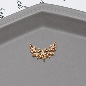 Detailed view of gold flower filigree pendant connector with multiple DIY hanging loops