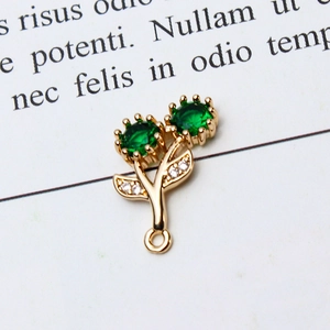 Macro detail of rose gold floral pendant with green zircon gemstones for DIY jewelry