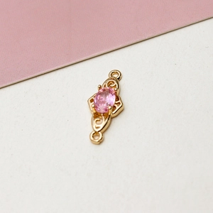 Close-up of pink zircon pendant connector with gold plating and double loops for DIY jewelry