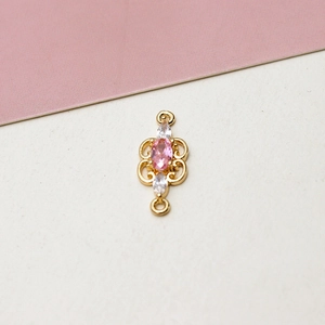 Detail of gold-plated pendant with pink oval zircon and double loops for DIY jewelry