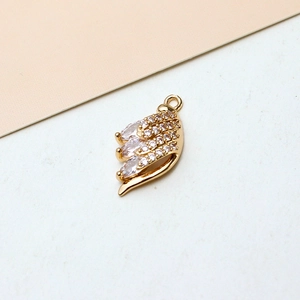 Macro shot of gold-plated wing charm with marquise zirconia for DIY jewelry making