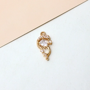 Macro shot of gold plated dolphin pendant with zircon inlay for DIY jewelry making