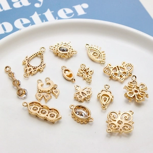 Golden micro-p镶 zircon charms for DIY jewelry on a white ceramic plate