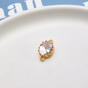 Close-up of golden crown-style connector with oval zircon for DIY jewelry making