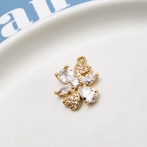 Macro view of gold-plated clover pendant with zircon inlay for jewelry making