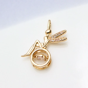 Detail of fairy pendant in gold plating with dancing stone and zircon wings