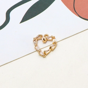 Macro detail of heart pendant with rectangular cubic zirconia in gold plating