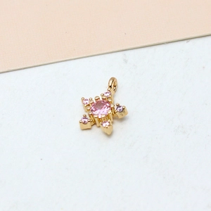 Macro shot of gold-plated star pendant with pink zircon crystals for DIY jewelry making