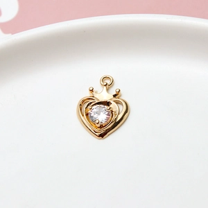 Macro shot of gold-plated hollow heart crown pendant with sparkling zircon gemstone inlay