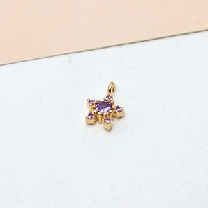 Macro view of gold-plated star pendant with inset purple zircon stones for DIY jewelry