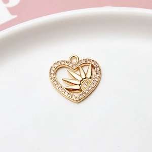 Detailed view of gold plated heart pendant with zircon sunburst and micro pave edge