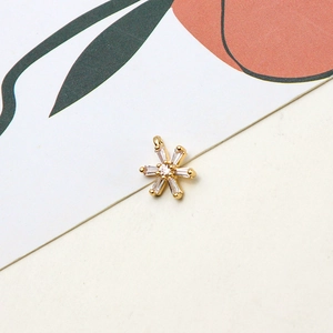 Detailed view of micro-pave zircon flower pendant with rectangular crystals and gold plating