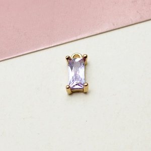 Macro shot of rectangular lavender zircon pendant with gold plated four-claw setting