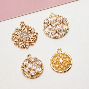 Gold plated flower and sunburst pendants with micro-pave cubic zirconia crystals