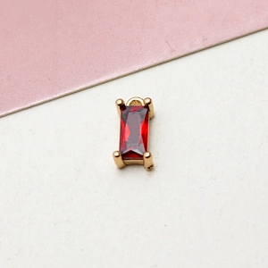 Macro detail of a rectangular red zircon pendant with gold plated brass claws for DIY jewelry