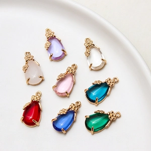 Detail of pear-shaped glass crystal drop pendants with gold flower-edged metal bases