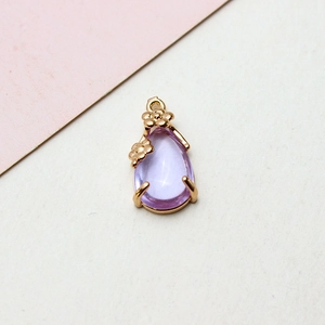 Detail of purple teardrop crystal pendant with gold flower frame for DIY jewelry