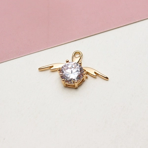 Detailed close-up of a gold-plated angel wing pendant with a central round zircon stone