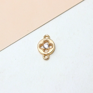 Macro view of gold plated clover connector charm with sparkling zircon for DIY jewelry