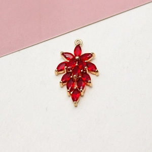 Close-up of gold-plated leaf pendant with red marquise cubic zirconia for DIY jewelry