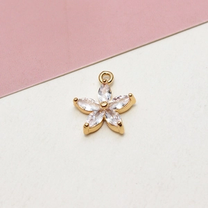 Detailed view of gold plated five petal flower pendant with marquise cut zircon stones