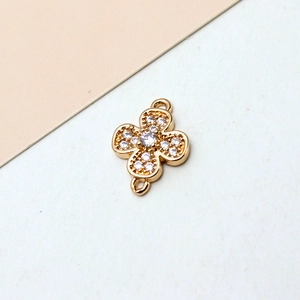 Macro shot of gold-plated clover jewelry connector with cubic zirconia for DIY jewelry