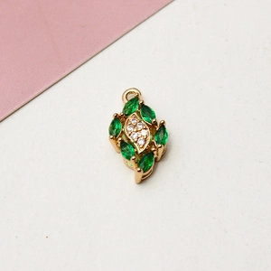 Detailaufnahme eines vergoldeten Tropfenanhängers mit grünen Zirkonia für DIY-Schmuck
