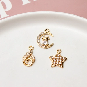 Gold-plated brass pendants with moon, star, and swan motifs featuring white zirconia inlay