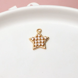 Macro view of a gold-plated star pendant with zircon stones for DIY jewelry making