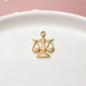 Macro shot of gold-plated scale pendant with micro-set zircons for DIY jewelry